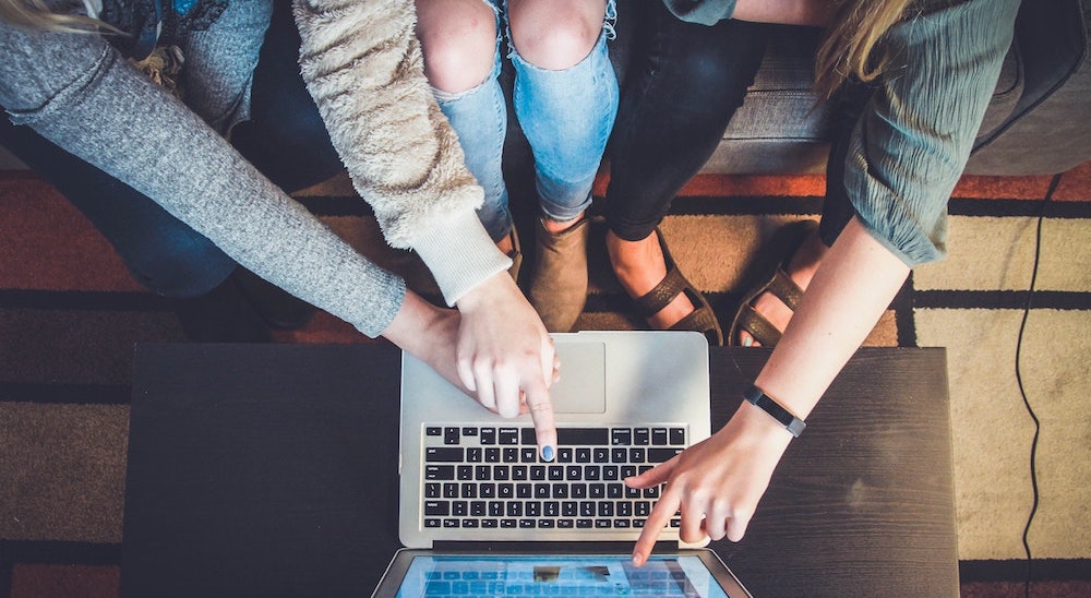 group of people around a laptop