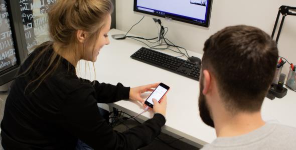 Blonde lady user testing an app on a phone