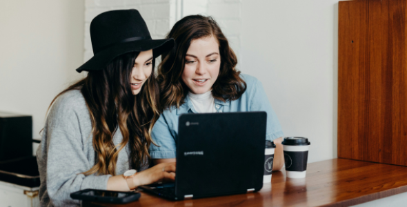Two women looking at a laptop
