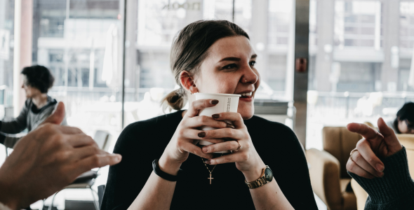 Woman enjoying a takeaway coffee she just ordered online