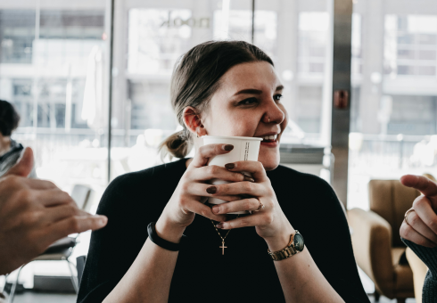 Woman enjoying a takeaway coffee she just ordered online