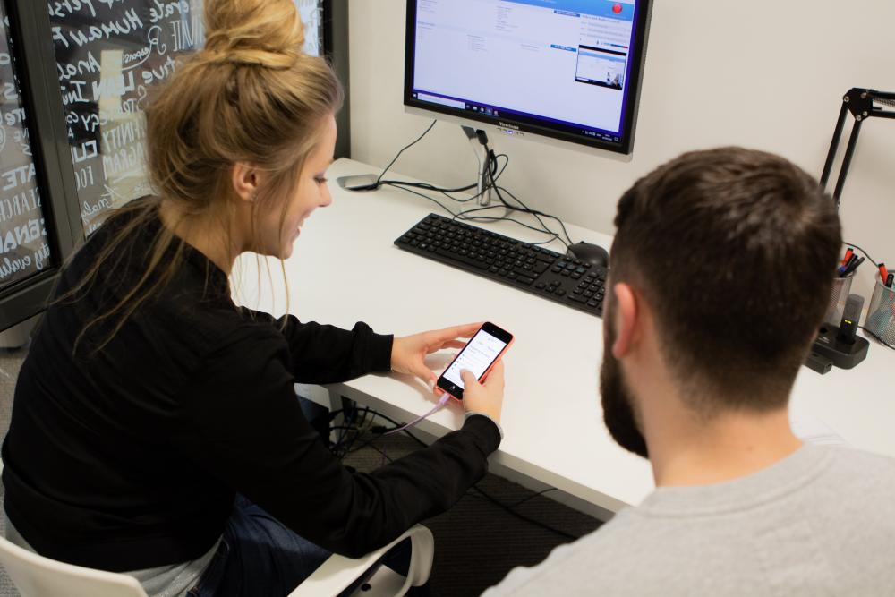 Blonde lady user testing an app on a phone