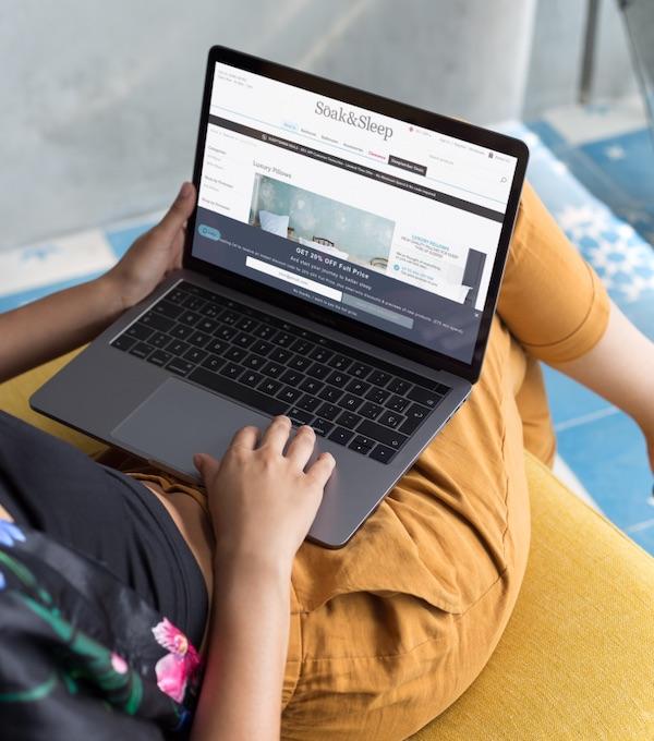 Laptop on lap showing Soak and Sleep website