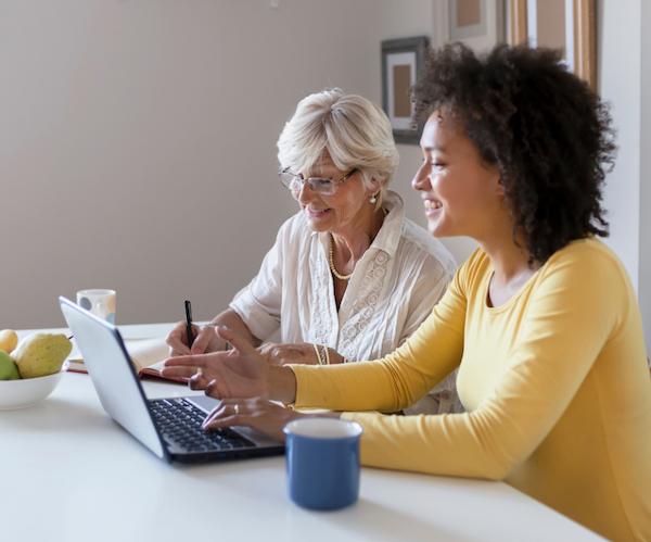 Two female consumers on a laptop