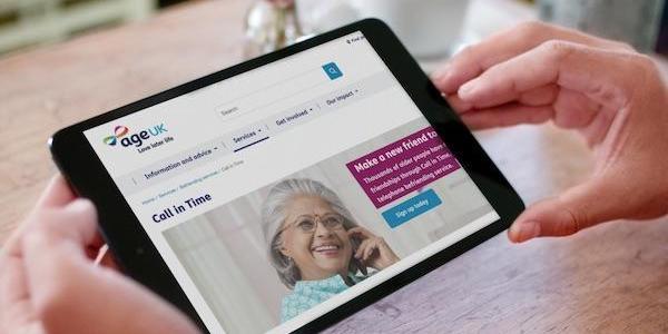 AgeUK website being operated by a person on a tablet device