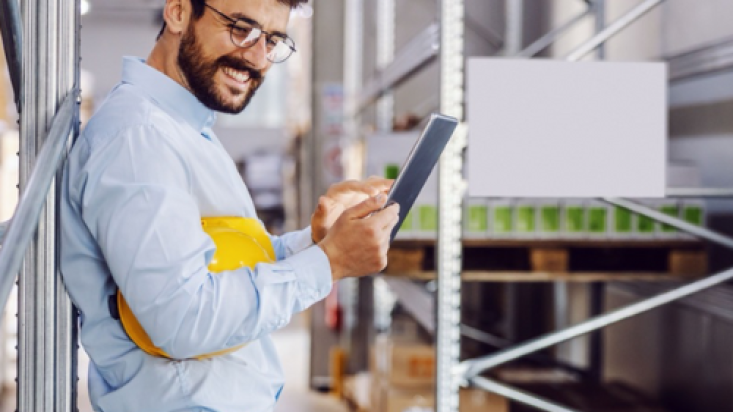 Man in stockroom looking at tablet