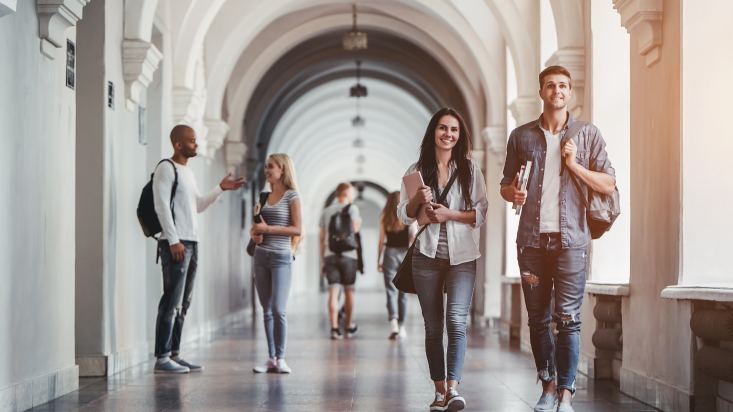 Image of students walking down hall