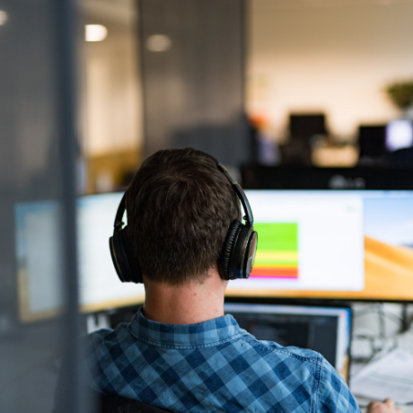 Person at his workstation with headphones